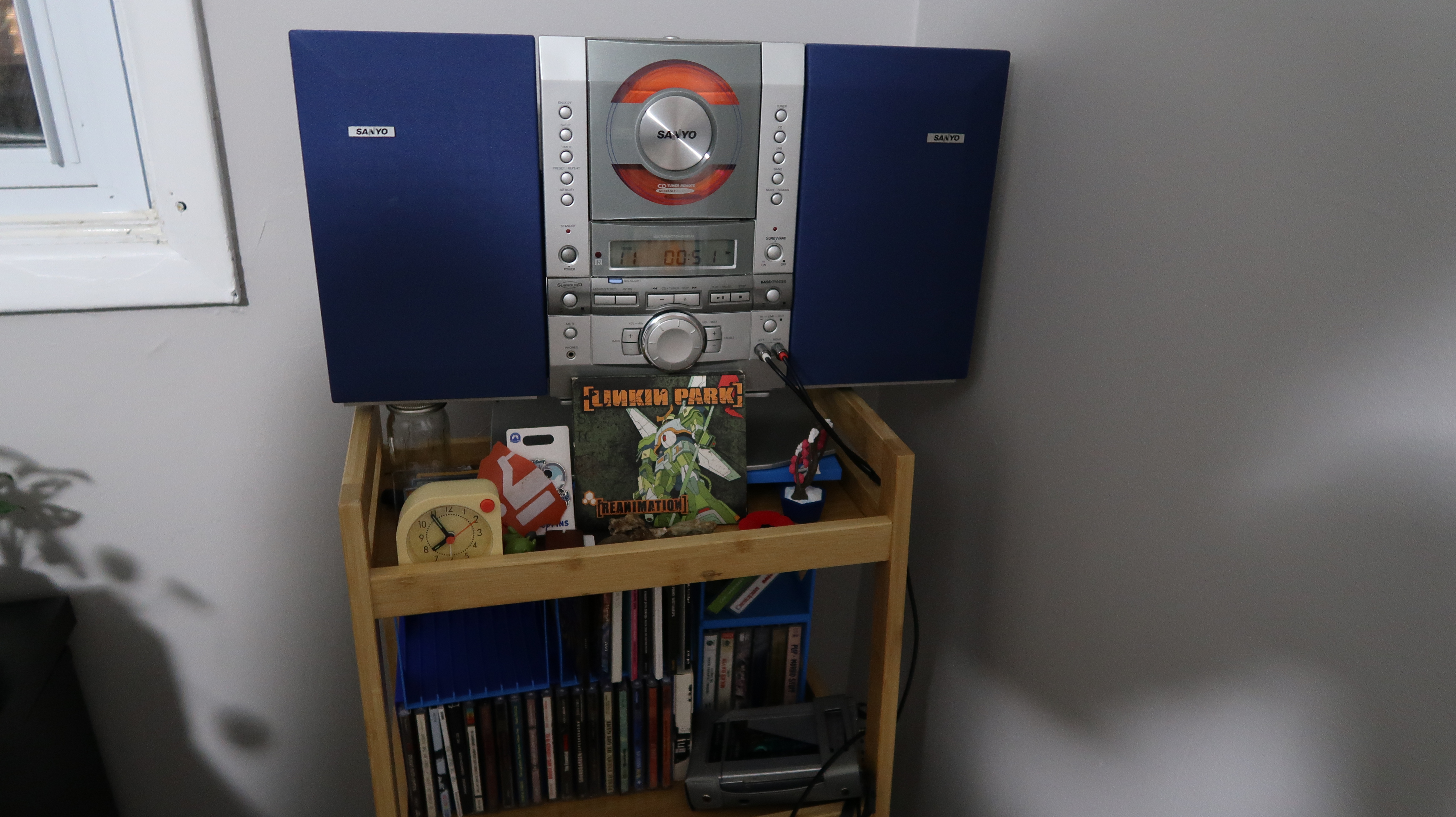 picture of a CD player on a shelf with CDs underneath